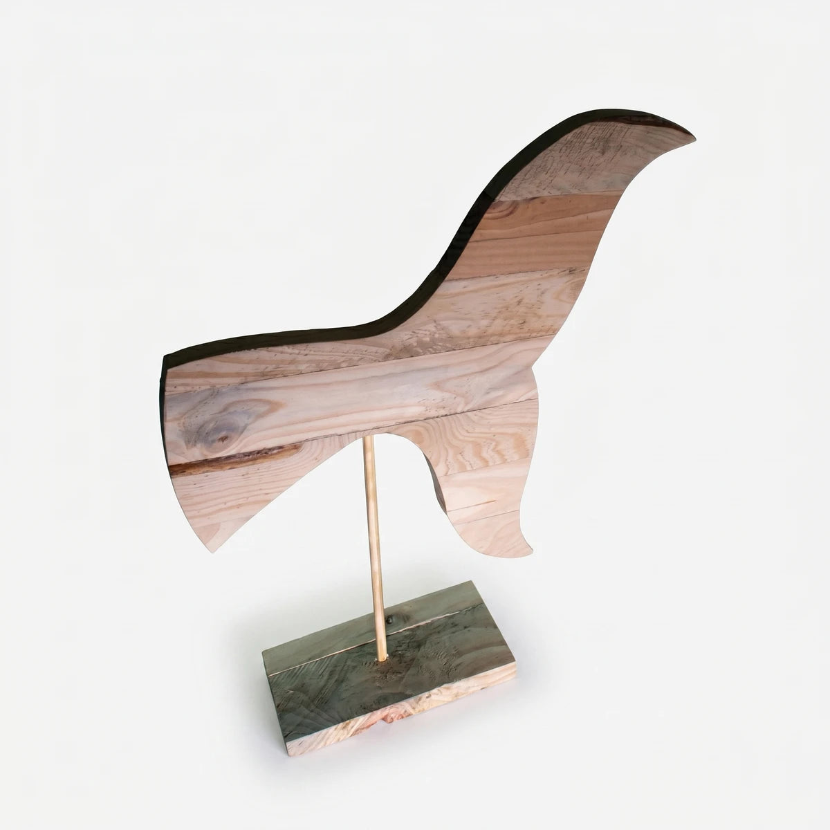 Small wooden whale tail sculpture with natural raw wood grain, displayed upright on a dark base stand, perfect for coastal