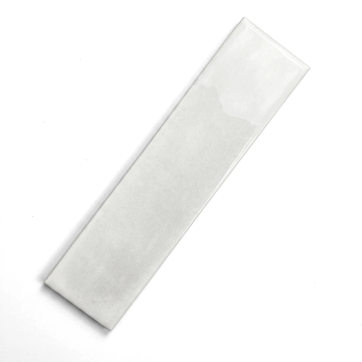 White 75X300mm Snowflake subway tile with a glossy finish, displayed diagonally on a gray surface.