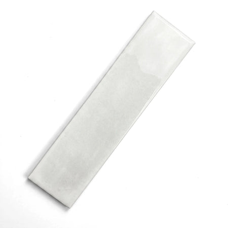 White 75X300mm Snowflake subway tile with a glossy finish, displayed diagonally on a gray surface.