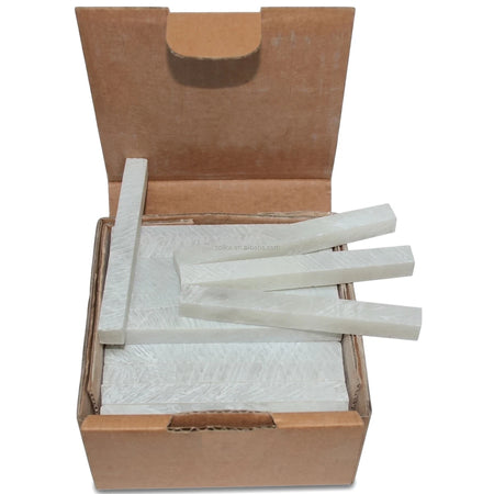 Open cardboard box of white rectangular soapstone (Boiler Makers) chalk sticks, neatly stacked inside for industrial use.