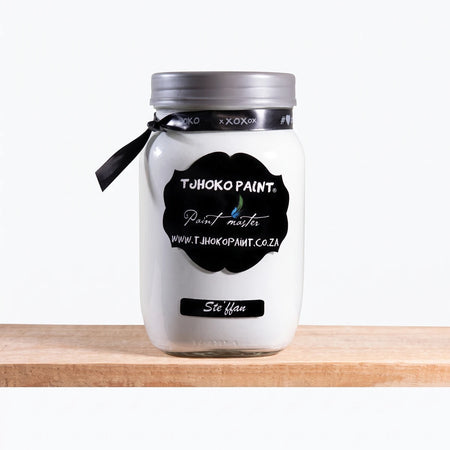 Stefann 1L Chalk Paint in a white glass jar with a black label and silver lid, resting on a wooden surface.