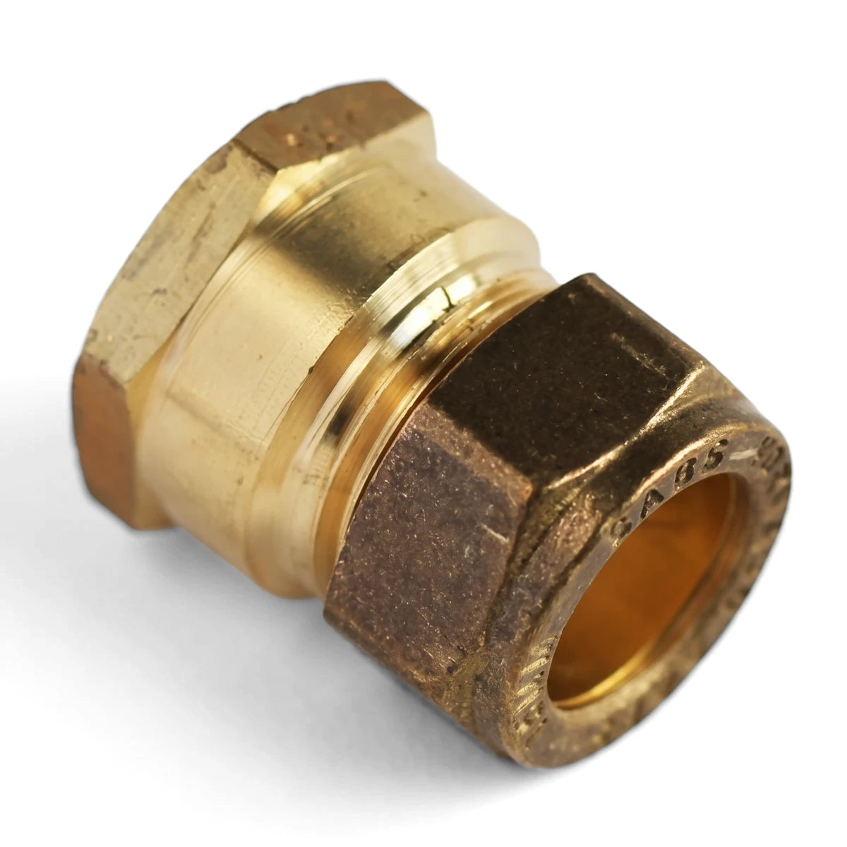 A shiny brass straight CXF coupling, a common plumbing fitting, displayed with its hexagonal nut and smooth barrel on a
