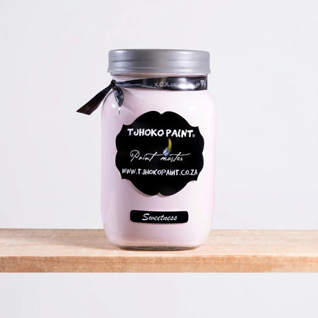 Sweetness 250ml Chalk Paint in a glass jar with a silver lid and black ribbon, displayed on a wooden shelf.