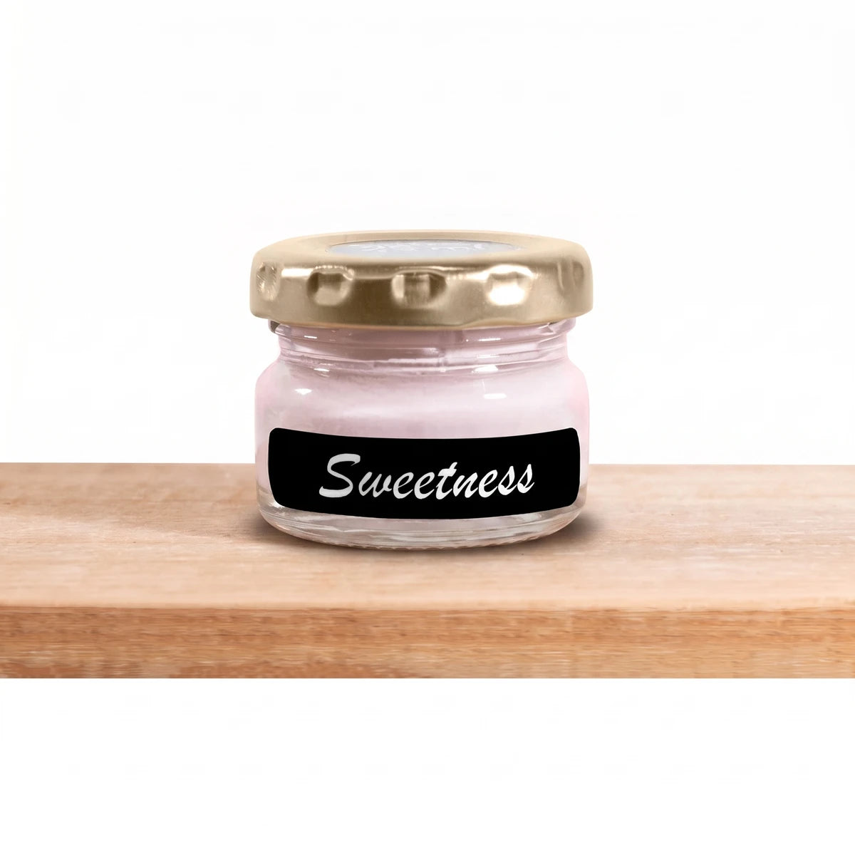 Small glass jar of Sweetness 25ml Chalk Paint with a gold lid and black label, containing light pink paint, displayed on a