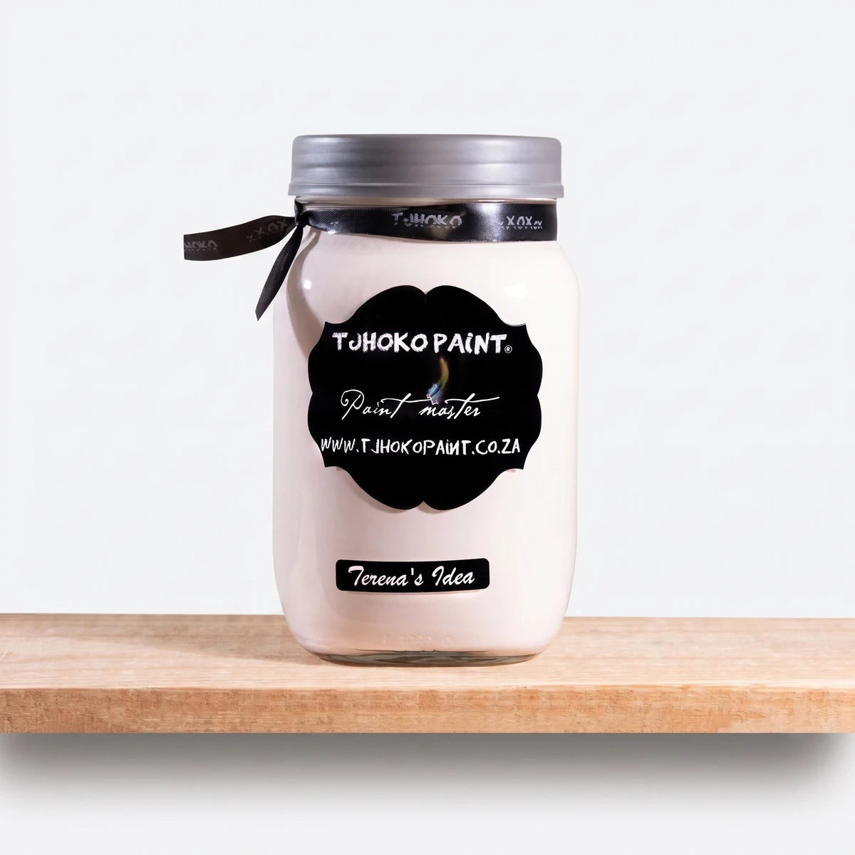 Terena's Idea 250ml chalk paint in a white jar with a black label, silver lid, and black ribbon on a wooden shelf.