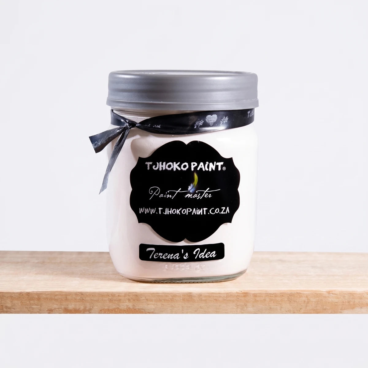 Terena's Idea 500ml Chalk Paint in a white jar with a grey lid and black label, resting on a wooden shelf.