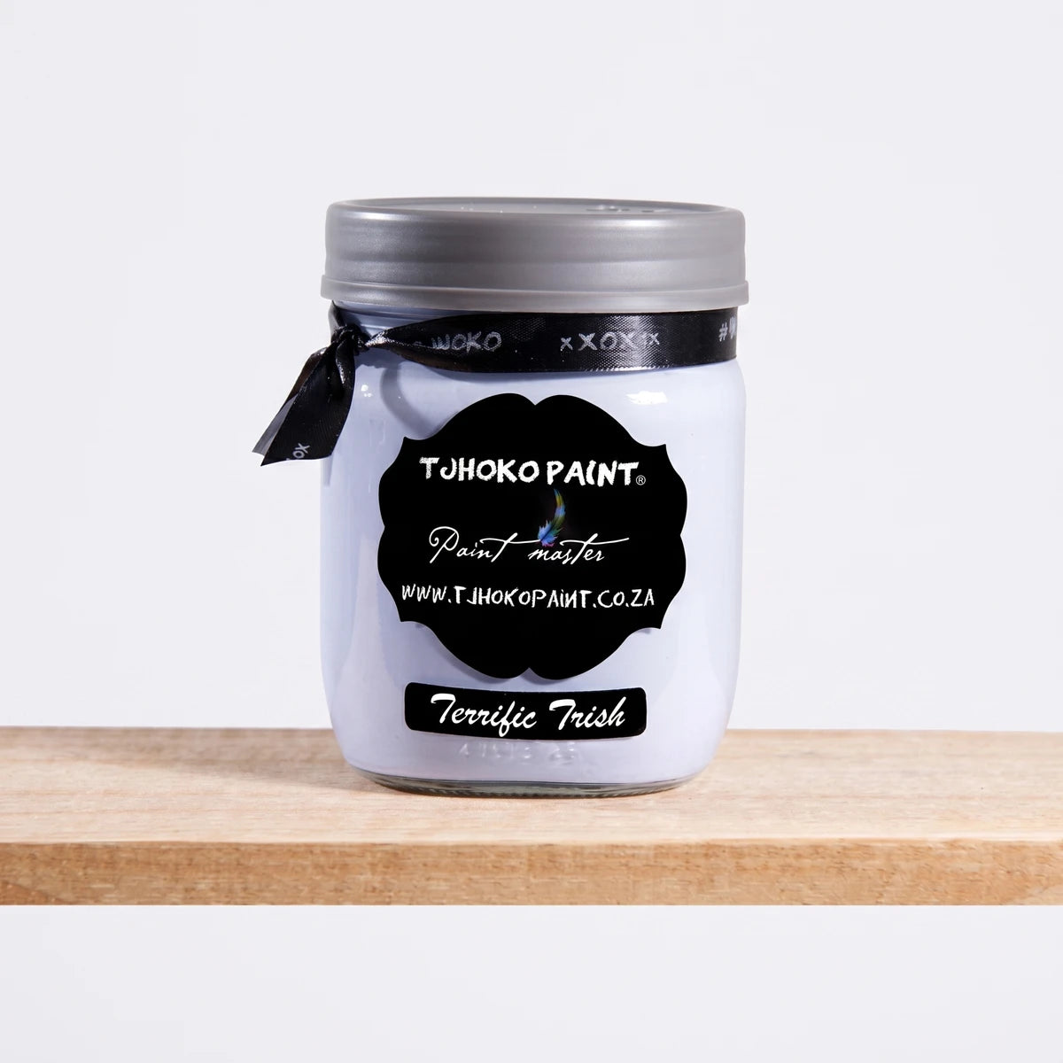 Terrific Trish 500ml Chalk Paint in a white glass jar with a black label and silver lid, photographed in a studio setting.