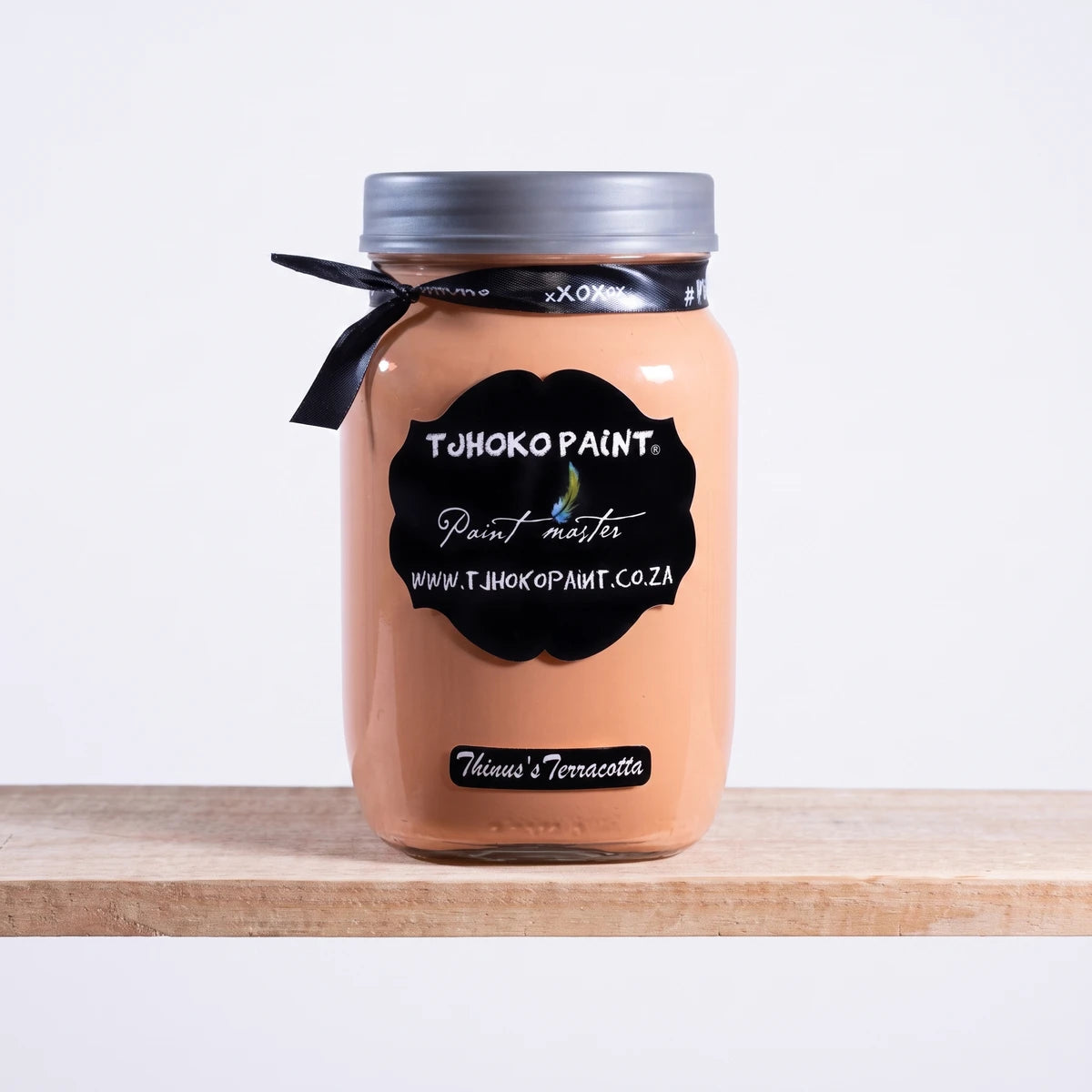 Thinus's Terracotta 1L Chalk Paint jar in a terracotta/peach color, featuring a black label, silver lid, and black ribbon.