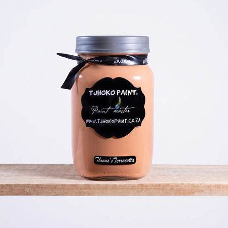 Thinus's Terracotta 1L Chalk Paint jar in a terracotta/peach color, featuring a black label, silver lid, and black ribbon.