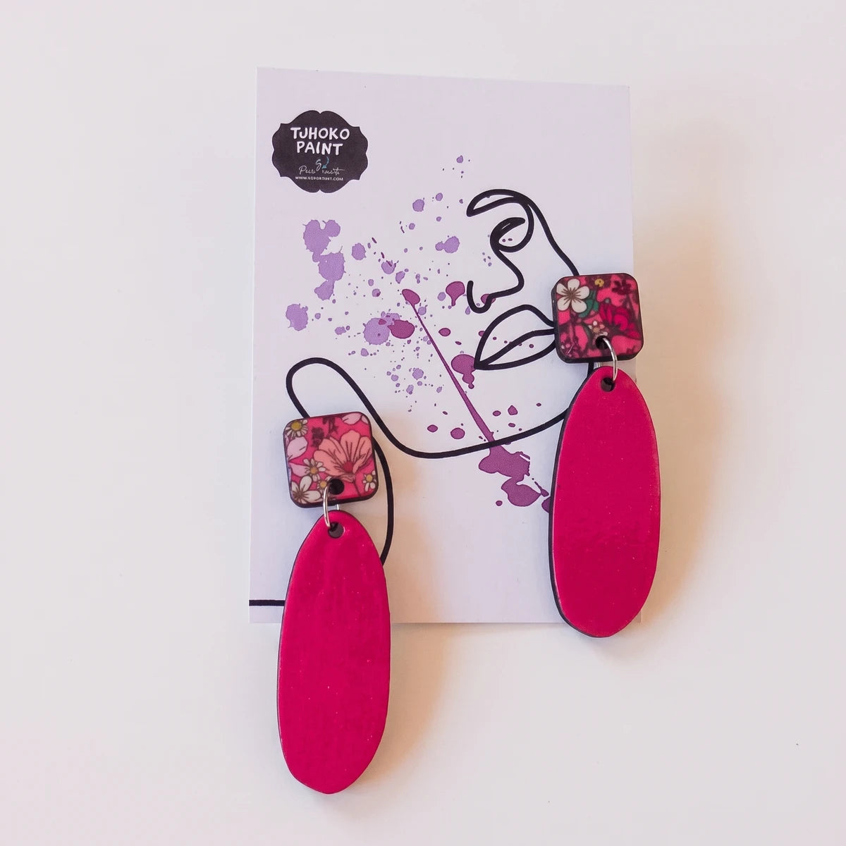 Tjhoko Earrings Range Pretty's Pink Daisies Earrings with bright pink oval drops and floral square tops displayed on a card.