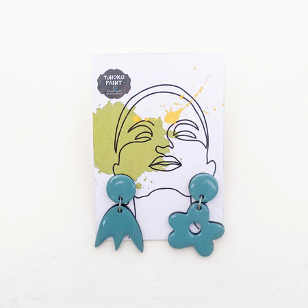 Teal polymer clay Nade's Perfect Match earrings in abstract flower and organic shapes, displayed on a white card.