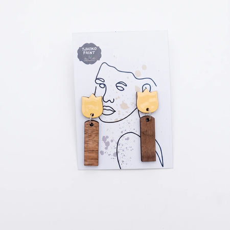 A pair of Tjhoko Not Too Shabby Tulips earrings featuring yellow tulip-shaped tops and dark brown wooden rectangle dangles,