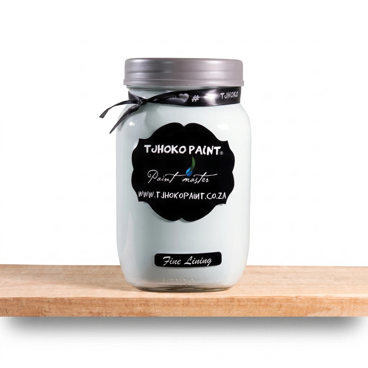 Tjhoko Paint Fine Lining 1L chalk paint in a clear glass jar with a black label, displayed on a wooden shelf.
