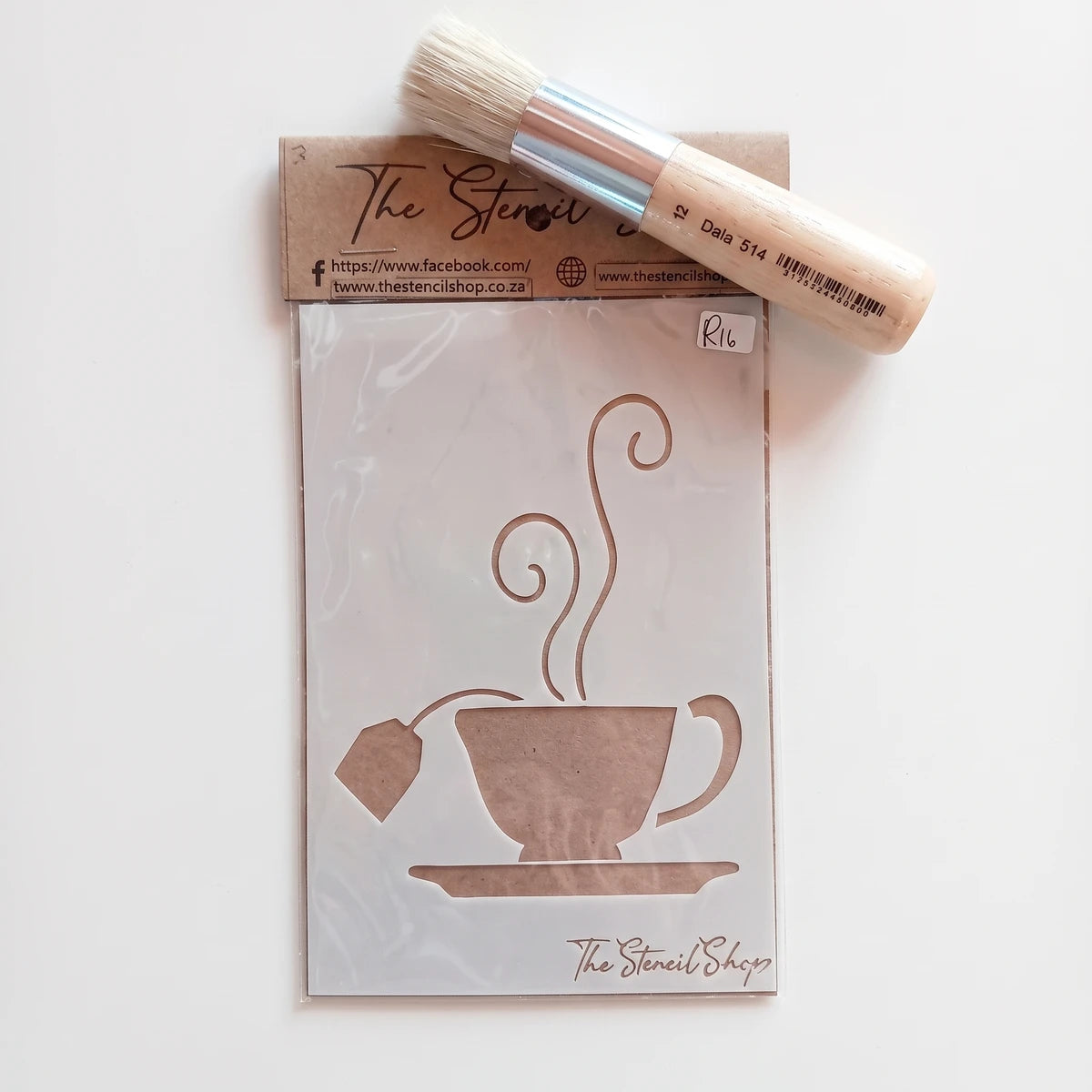 Tjhoko Stenc A6-3 Hartjie paint stencil with a tea cup design, accompanied by a natural bristle paint brush, shown from a