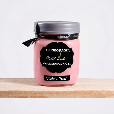 Tjohoko Paint Tinkie's Treat 500ml chalk paint in a clear glass jar with a gray lid and black ribbon, displayed on a wooden