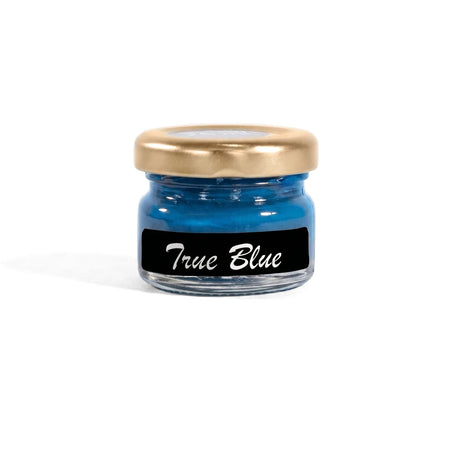 True Blue 25ml chalk paint in a clear glass jar with a gold lid and a black label, sitting on a wooden shelf.