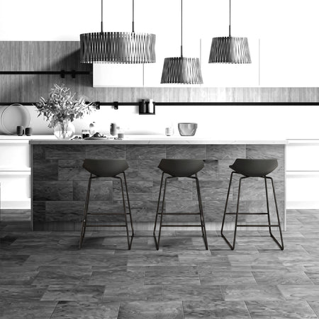 Modern kitchen island clad in Tzaneen Brown 25x49cm tiles, featuring a white countertop and three black bar stools.