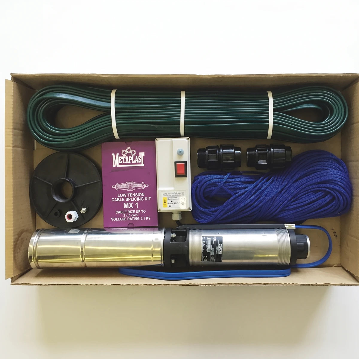Waterpack Borehole Pump Kit in a cardboard box, including a silver pump, green and blue cables, and various connectors.
