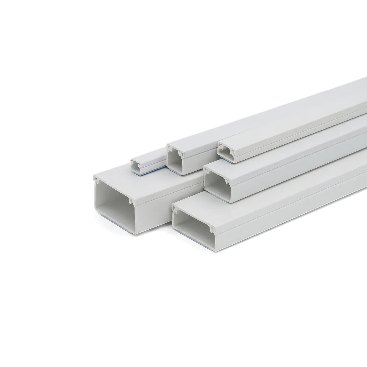 White PVC electrical cable trunking in various rectangular sizes, neatly stacked for cable management applications.