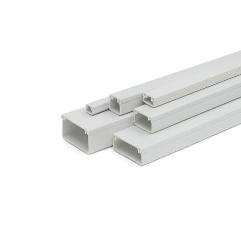 White PVC electrical trunking in various sizes, arranged diagonally on a white background, showcasing the open channels.