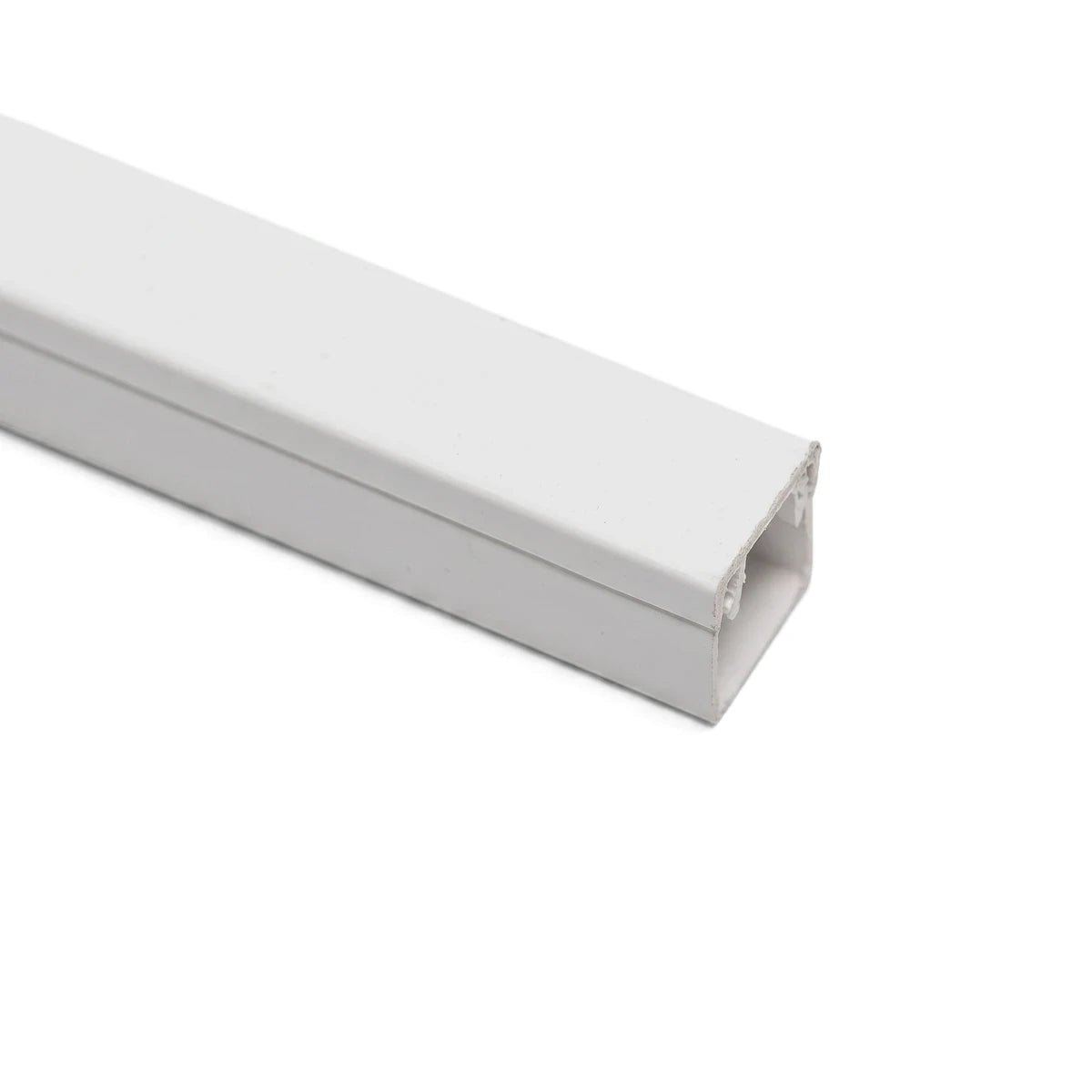White square PVC electrical cable trunking, photographed from an angle, showcasing its protective channel design.