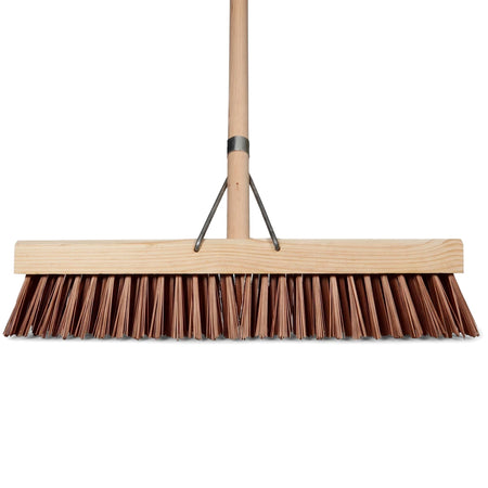 Front view of a brown flagged broom with a light wooden head and handle, designed for sweeping various surfaces.